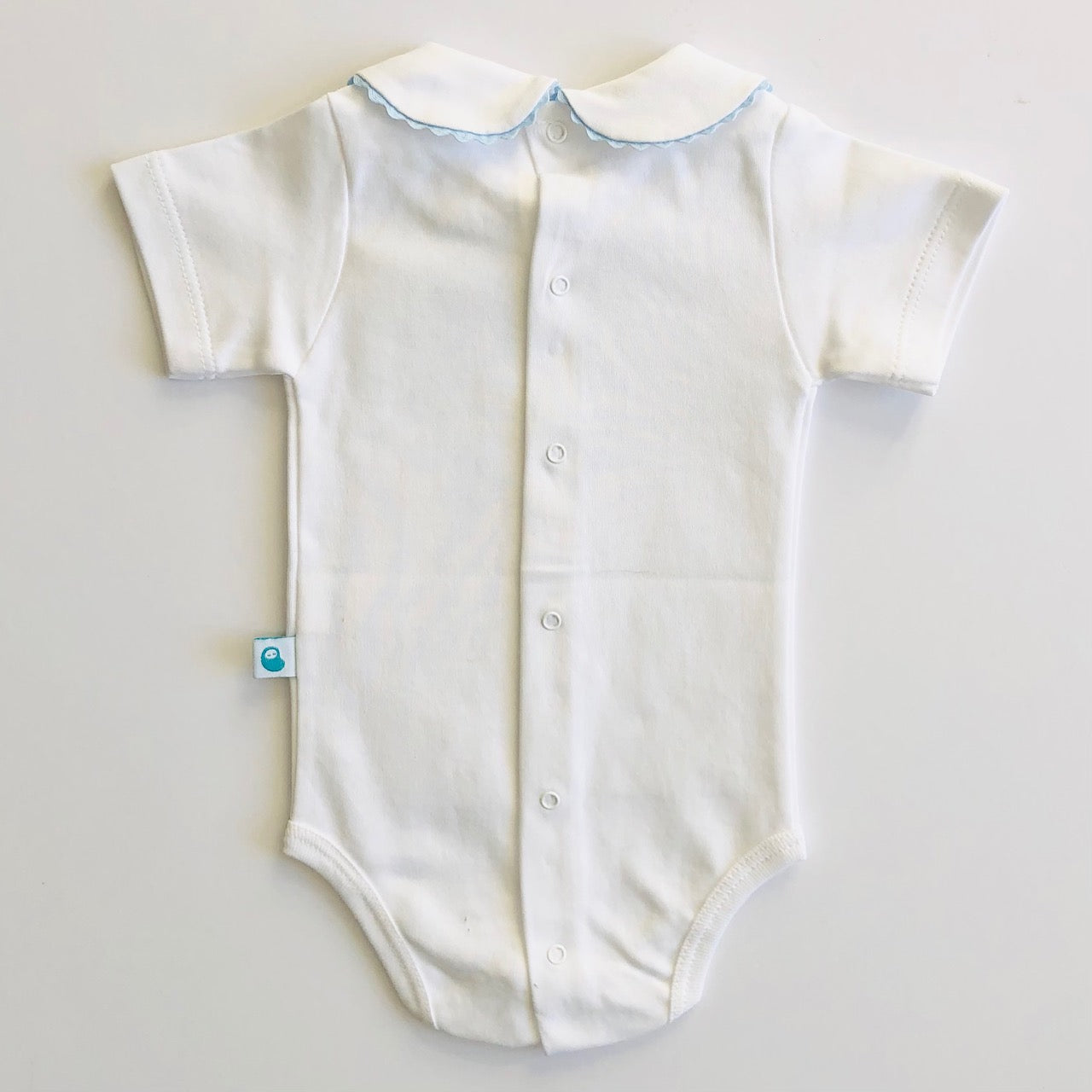 Baby vest with blue ric rac collar. Back view