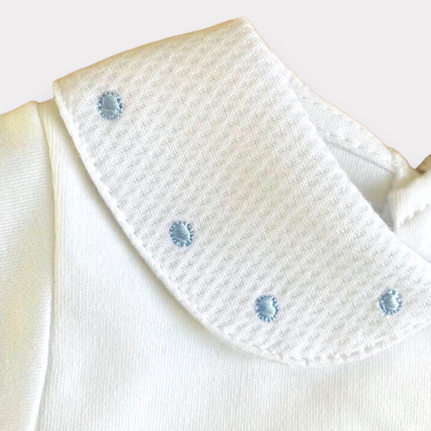 Baby vest with blue spot embroidered collar