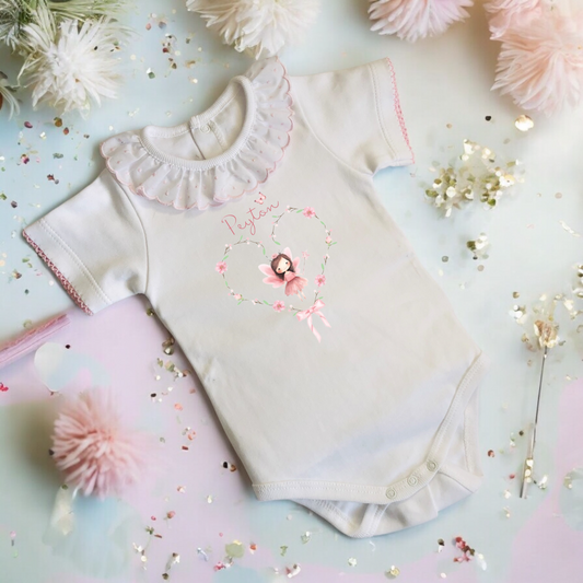Baby vest with pink frilly collar